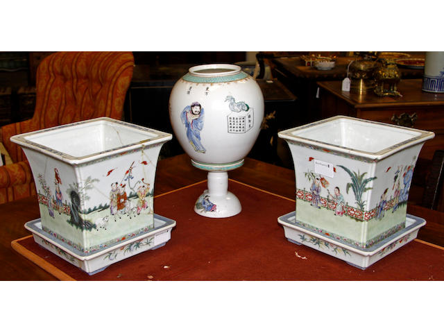 A Pair of Chinese 'famille rose' Jardinieres and Stands,red four character seal marks, square tapering, painted around the sides with igures and animals in a fenced garden, 20cm, and a 'amille rose' table lamp and shade painted with figures and calligraphic inscriptions, 30cm. (6).