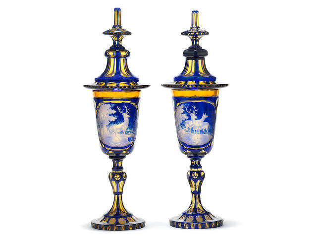 A rare pair of Bohemian blue and amber part-stained goblets and covers, circa 1850-70