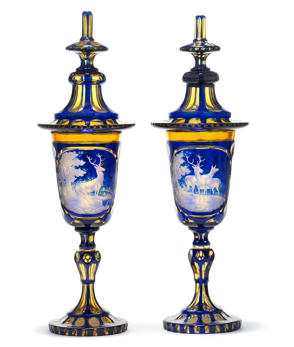 A rare pair of Bohemian blue and amber part-stained goblets and covers, circa 1850-70