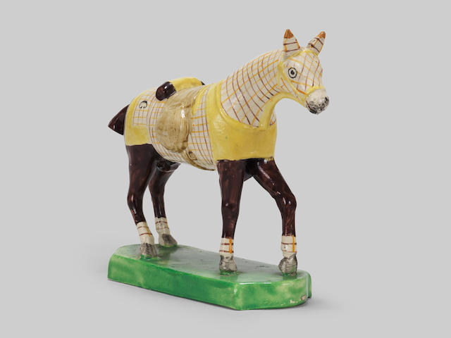 A very unusual Staffordshire model of a horse in a training blanket, circa 1810-20