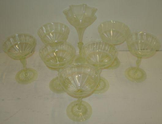 A set of seven James Powell & Sons champagne glasses, probably designed by Harry Powell in 'straw opal' glass, 14cm, together with a Venetian inspired vase with thrown rim, 20cm, pattern 837.See Lesley Jackson Whitefriars glass plate 19 page 101 for similar examples.