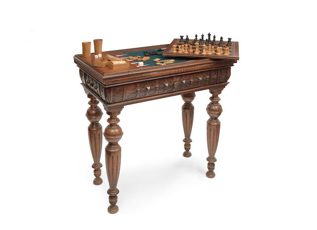 An early Victorian Elizabethan revival oak games table/compendium in the manner of Bridgens