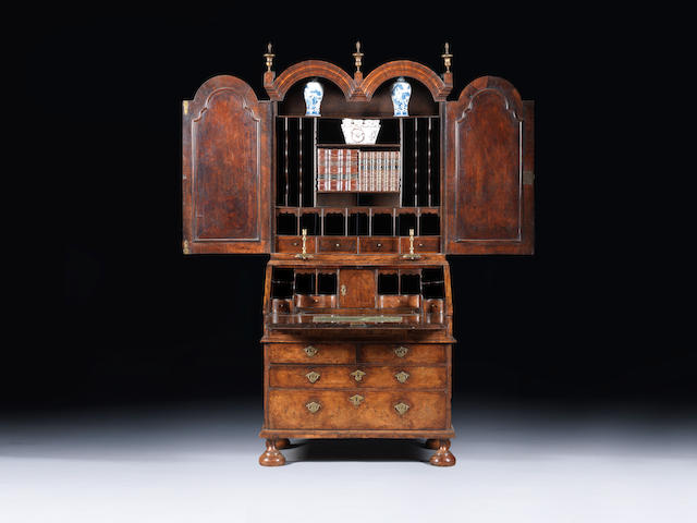 A Queen Anne walnut and featherbanded double domed bureau bookcase