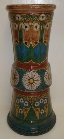 A late 19th Century Rozenberg pottery umbrella pot, decorated in the Arts & Crafts style with panels of flowers and leaves, painted mark 'No. 329 Den Haag', 59cm, damages.