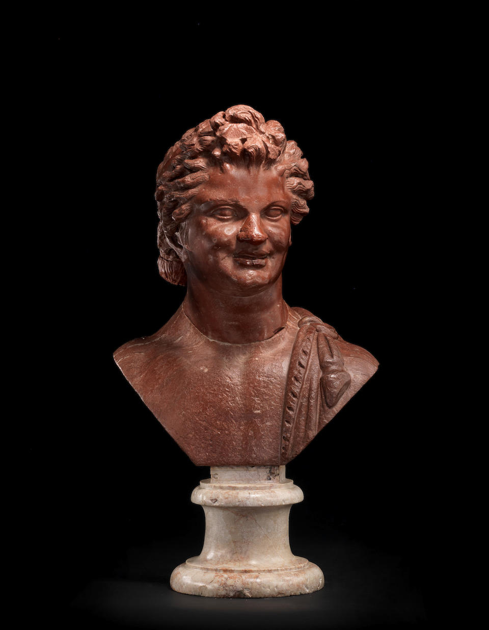 A Roman rosso antico marble head of a satyr