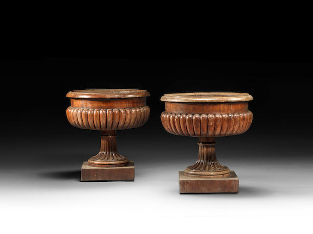 A pair of George IV carved mahogany wine coolers attributed to Gillows