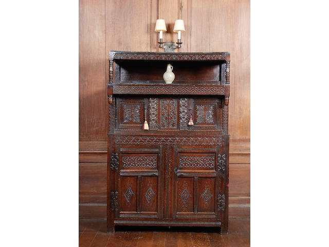 A rare Charles II oak canopied court cupboard, Westmorland, dated 1676