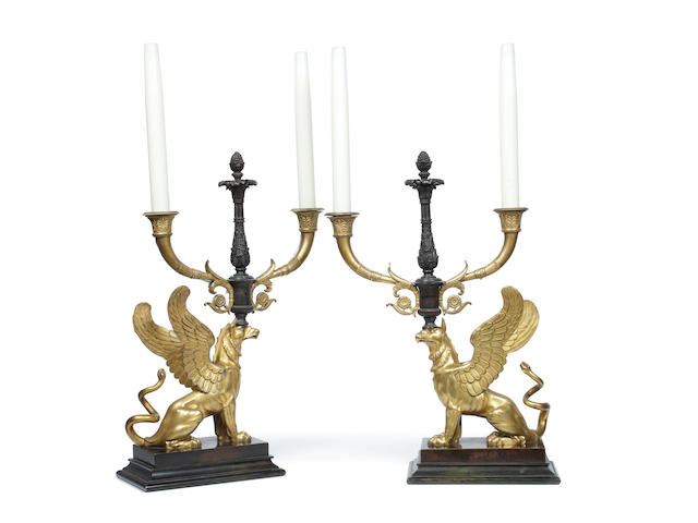 A pair of Empire ormolu and bronze twin branch candelabra