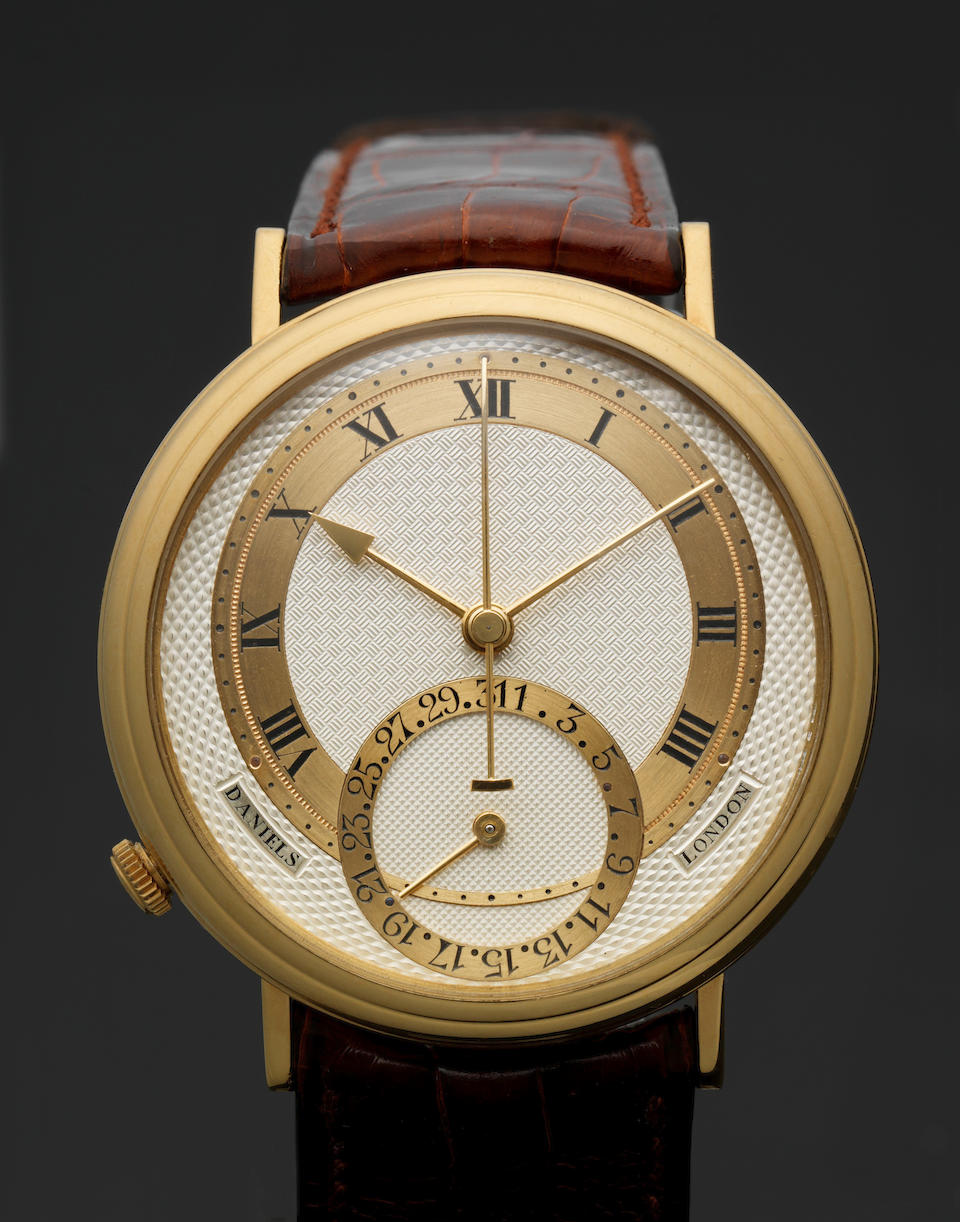 George Daniels. A very fine and rare 18ct yellow gold limited series automatic centre seconds calendar wristwatch with Co-Axial escapement with fitted box, papers and letters signed by George Daniels Millennium, Made in 1999