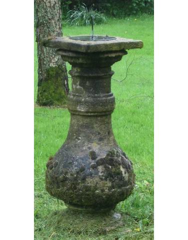 An early 20th century carved garden sun dial base with bronze sundial  The dial by T. Howes, Marlborough