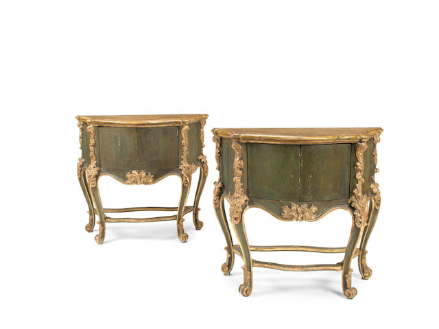 A pair of Italian 19th century Rococo revival painted and parcel gilt serpentine commodes