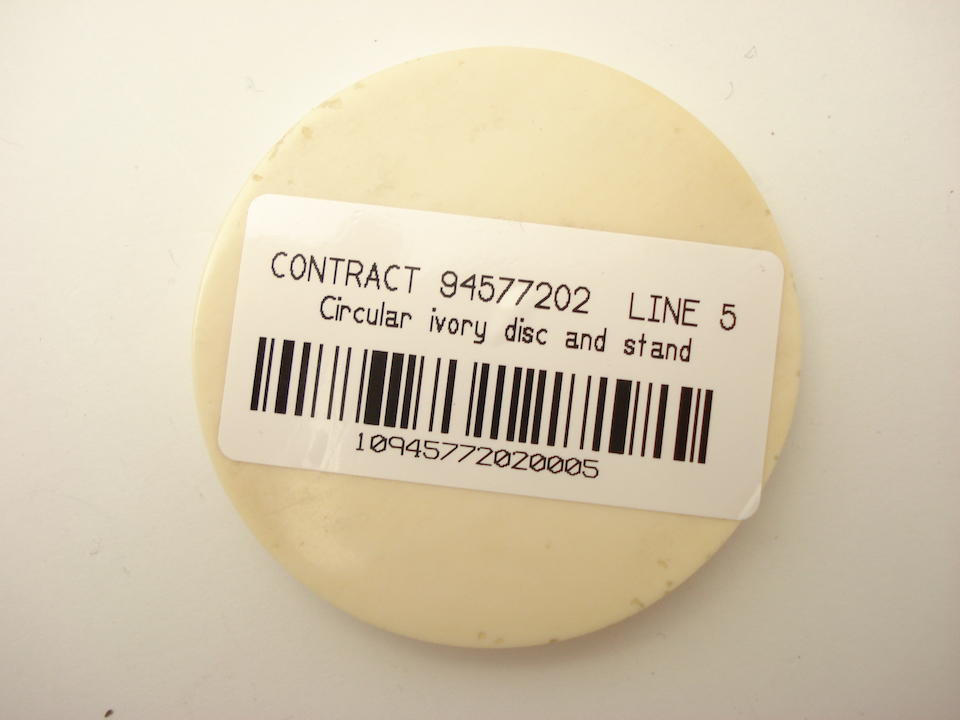 An inscribed circular ivory disc 20th century
