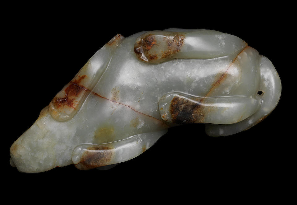 A pale green and russet jade carving of a dog Ming Dynasty, 16th/17th century (2)
