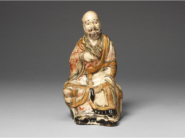 A Cizhou polychrome pottery figure of a Luohan Jin/Yuan Dynasty