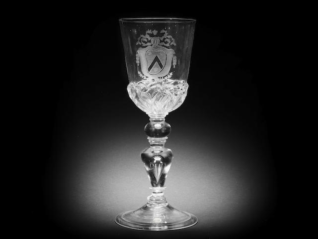 A fine and early engraved armorial baluster goblet, late 17th century