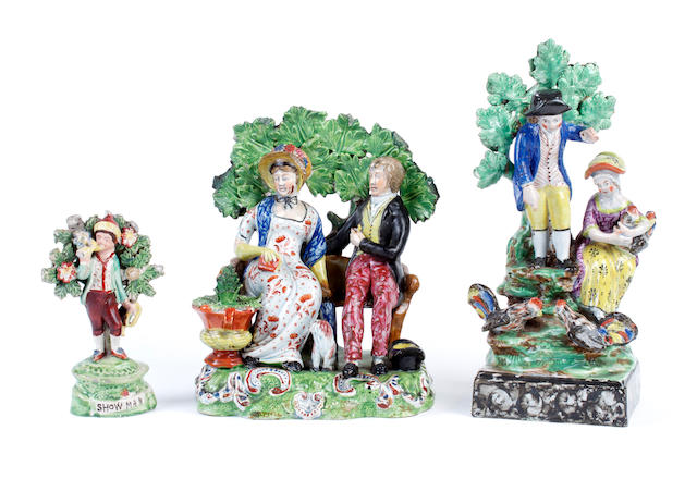 Two Staffordshire pearlware figure groups and a figure of a piper 'Showman', circa 1810-20