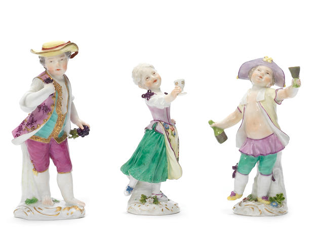 A pair of Meissen figures of dancing children with goblets, circa 1760, together with a Meissen boy, circa 1770
