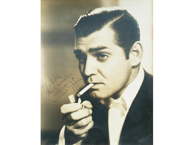 Clark Gable: A large sepia publicity photograph signed by the subject,