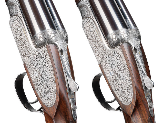 A fine pair of Kelly-engraved 12-bore single-trigger self-opening sidelock ejector guns by J. Purdey & Son, no. 29271/2 In their leather case with canvas cover
