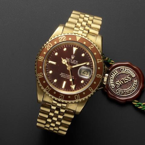 Rolex. A fine 18ct gold automatic calendar bracelet watch with dual timezone and 'root beer' bezel GMT Master, Ref:16758, Serial No.7077***, Movement No.072****, Circa 1981