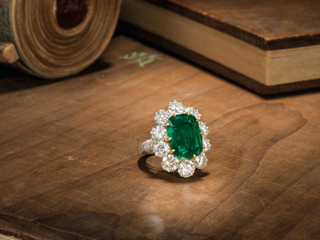 An important emerald and diamond cluster ring