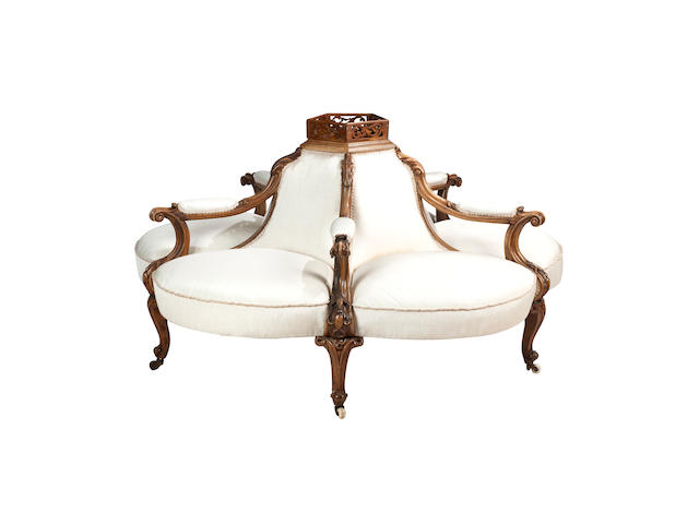 A Victorian walnut conversational sofa