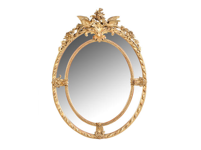 A pair of 19th Century giltwood and gesso oval pier mirrors
