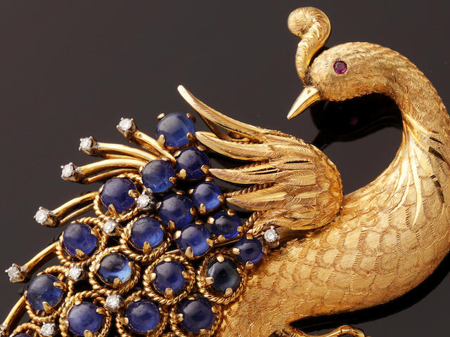 A sapphire and diamond set peacock brooch