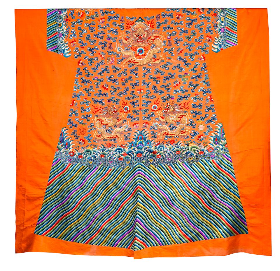An uncut silk 'Twelve Symbols' apricot yellow-ground robe Late 19th century