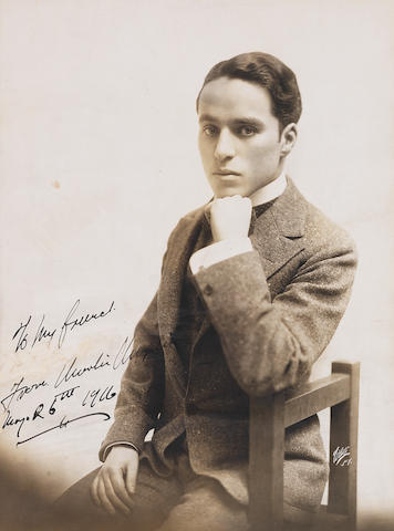 Charlie Chaplin: An early sepia publicity photograph signed,
