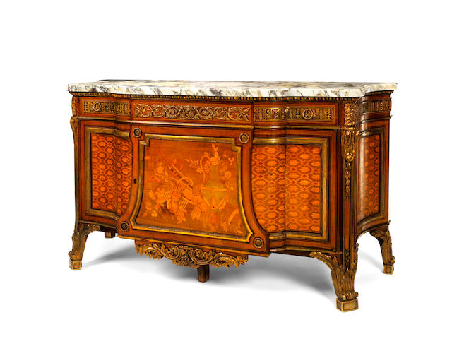 A French late 19th century gilt bronze mounted amaranth, sycamore and fruitwood marquetry and parquetry commode a vantaux after J.H. Riesener