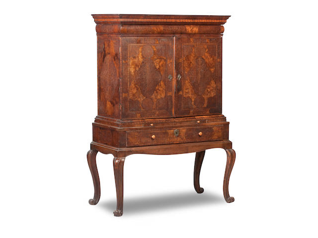 A William and Mary walnut and seaweed marquetry cabinet on later stand