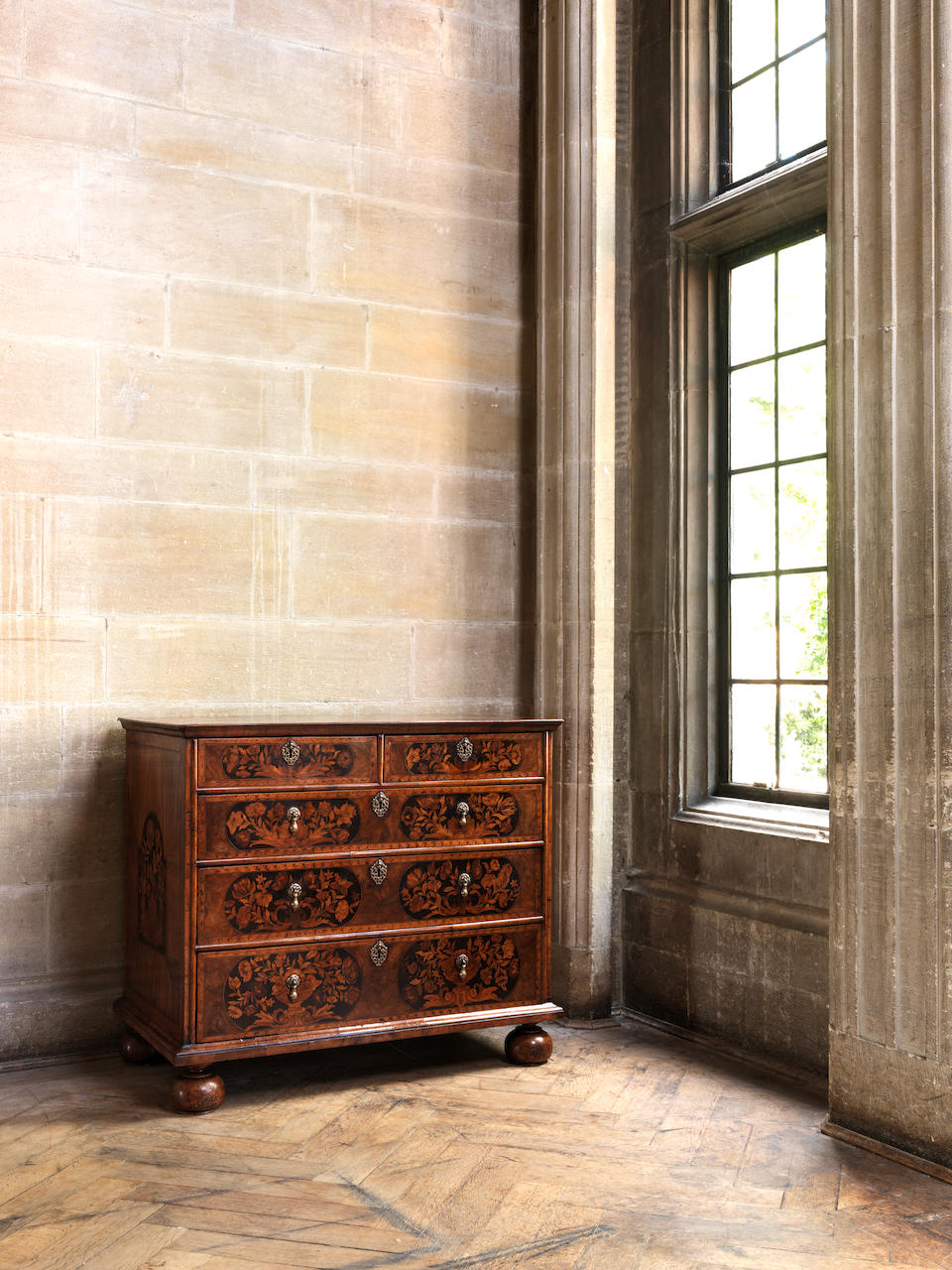 A William and Mary walnut and sycamore floral marquetry chest