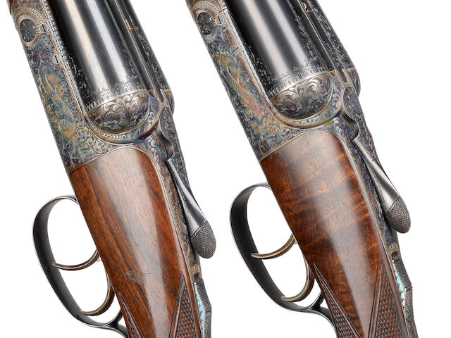 A fine pair of 12-bore round-action ejector guns by David Mckay Brown, no. 7487/8 In their brass-mounted oak and leather case with canvas cover