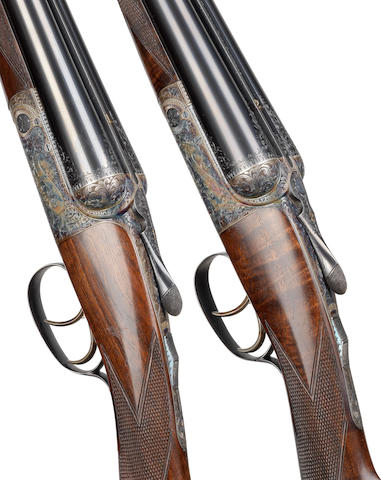 A fine pair of 12-bore round-action ejector guns by David Mckay Brown, no. 7487/8 In their brass-mounted oak and leather case with canvas cover