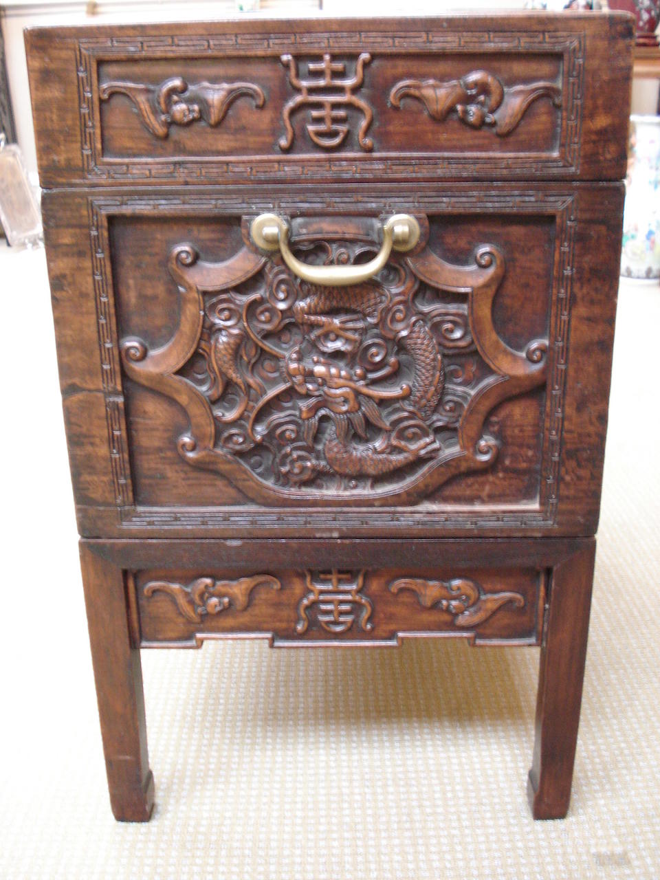 An impressive huanghuali carved trunk on stand 19th century