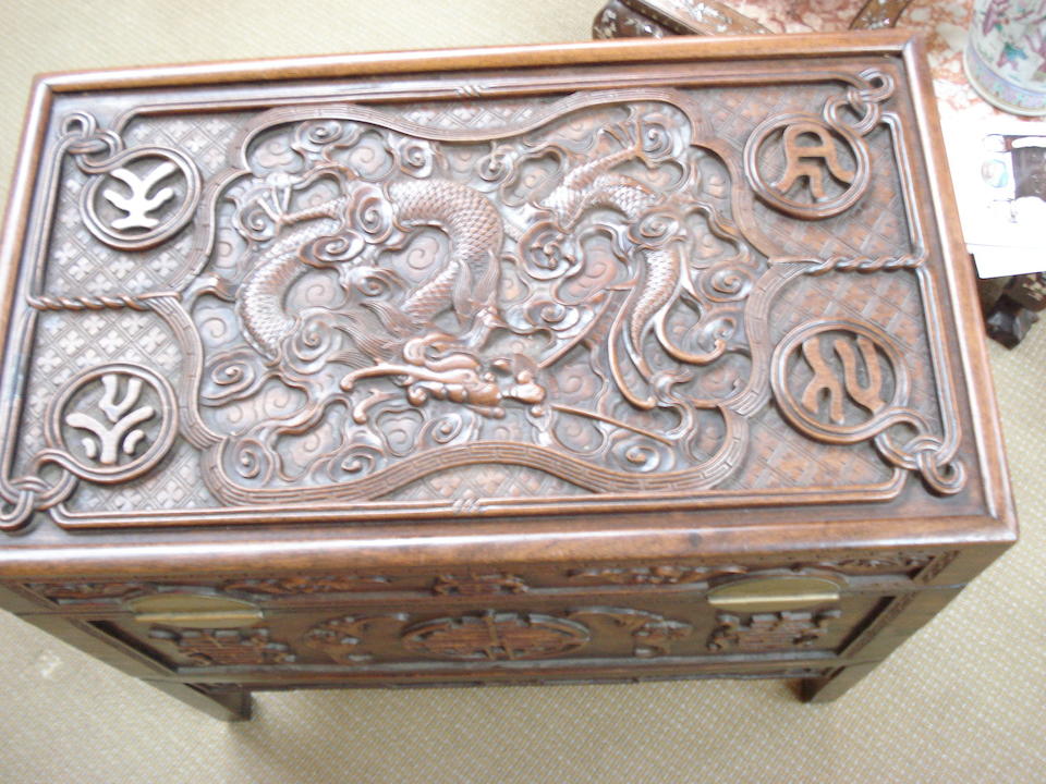 An impressive huanghuali carved trunk on stand 19th century