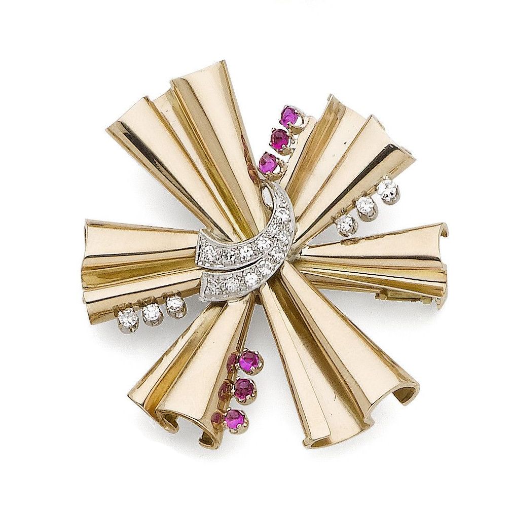 A ruby and diamond starburst brooch,