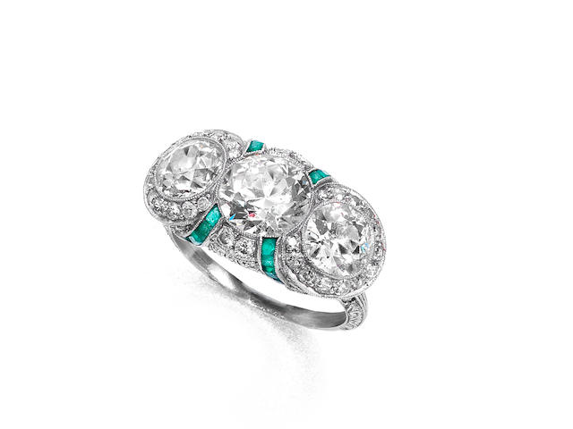 An emerald and diamond three-stone ring,