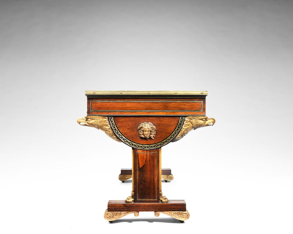 A fine Regency rosewood and crossbanded, ebony and brass inlaid and mounted parcel gilt library table the design attributed to Thomas Hope, the manufacture attributed to George Oakley