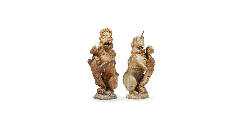 A rare pair of James I polychrome-decorated and parcel-gilt carved oak heraldic newel finials, the Lion and Unicorn supporters of the Royal Arms (2)