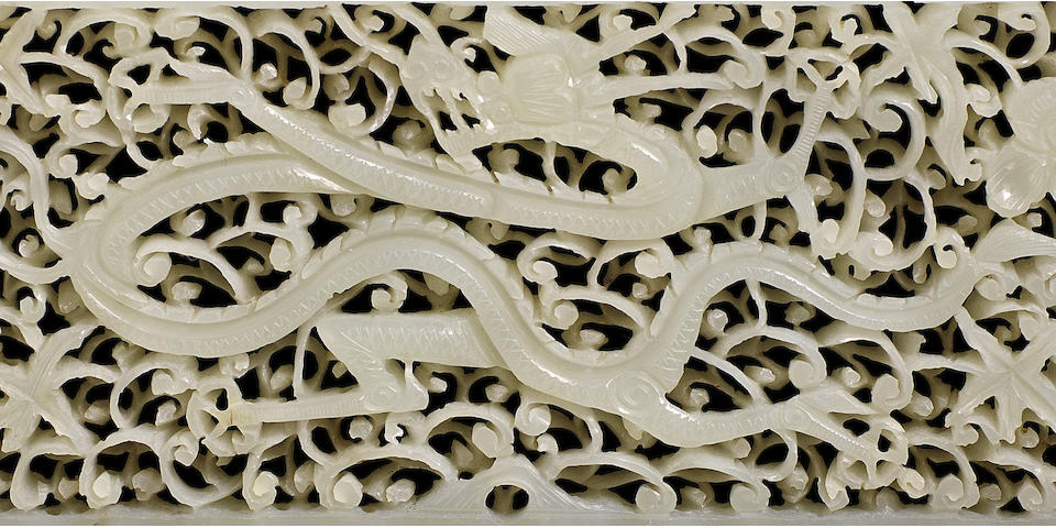 A pale green jade reticulated 'dragon' plaque Ming Dynasty