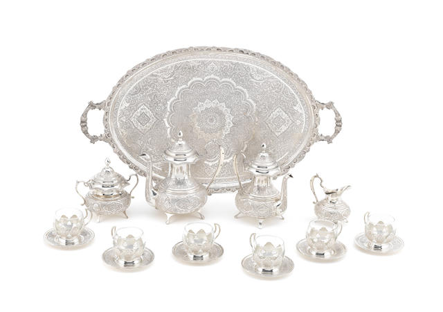 An Iranian metalware tray, tea and coffee service with cups and table accoutrements with .840 standard mark