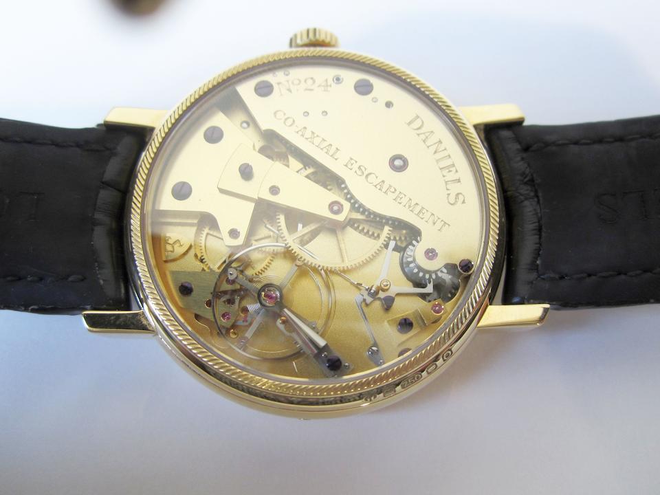 George Daniels. A very rare and fine 18K gold limited series manual wind instantaneous calendar wristwatch with power reserve indication, co-axial escapement and start stop mechanism, Daniels Anniversary Edition, No.24/35