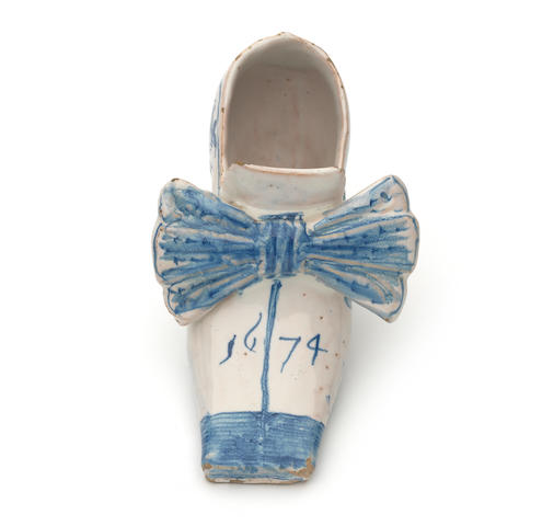 An important English delftware shoe, dated 1674