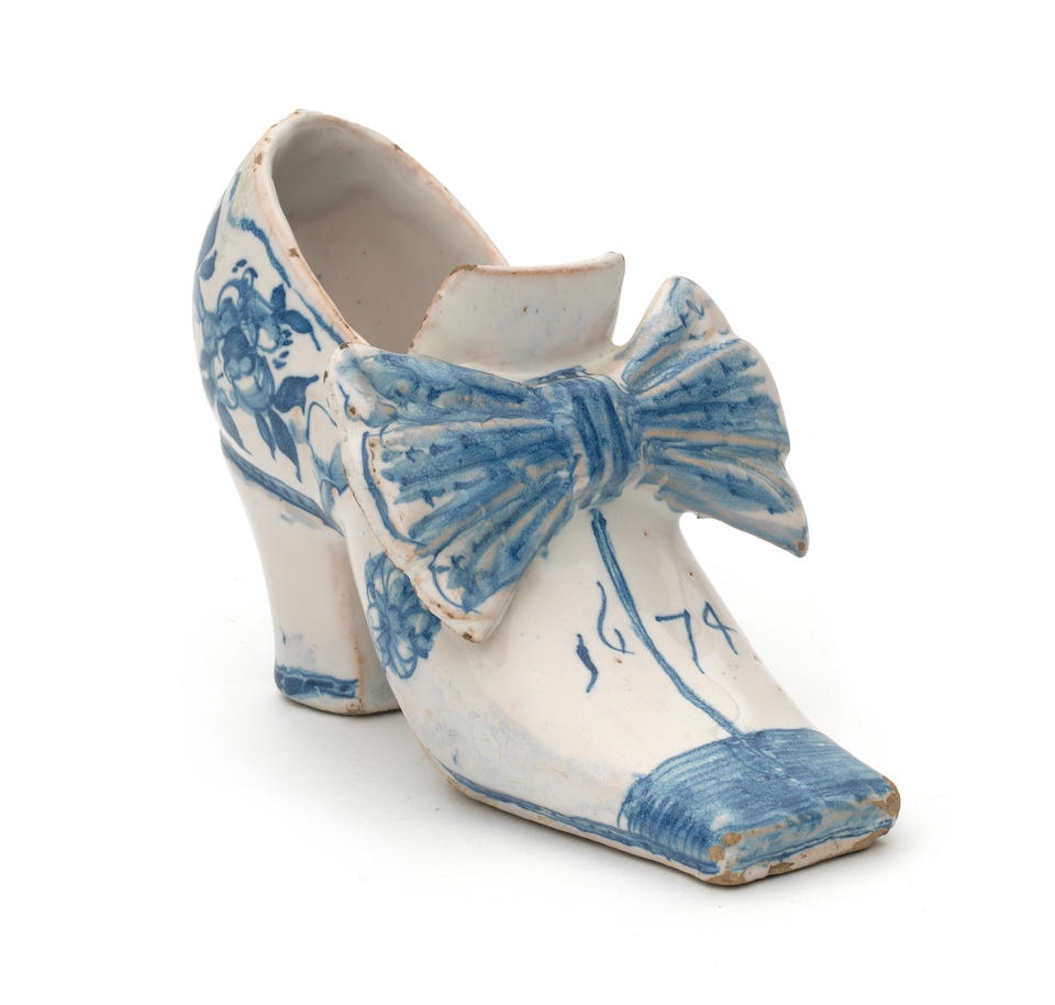 An important English delftware shoe, dated 1674