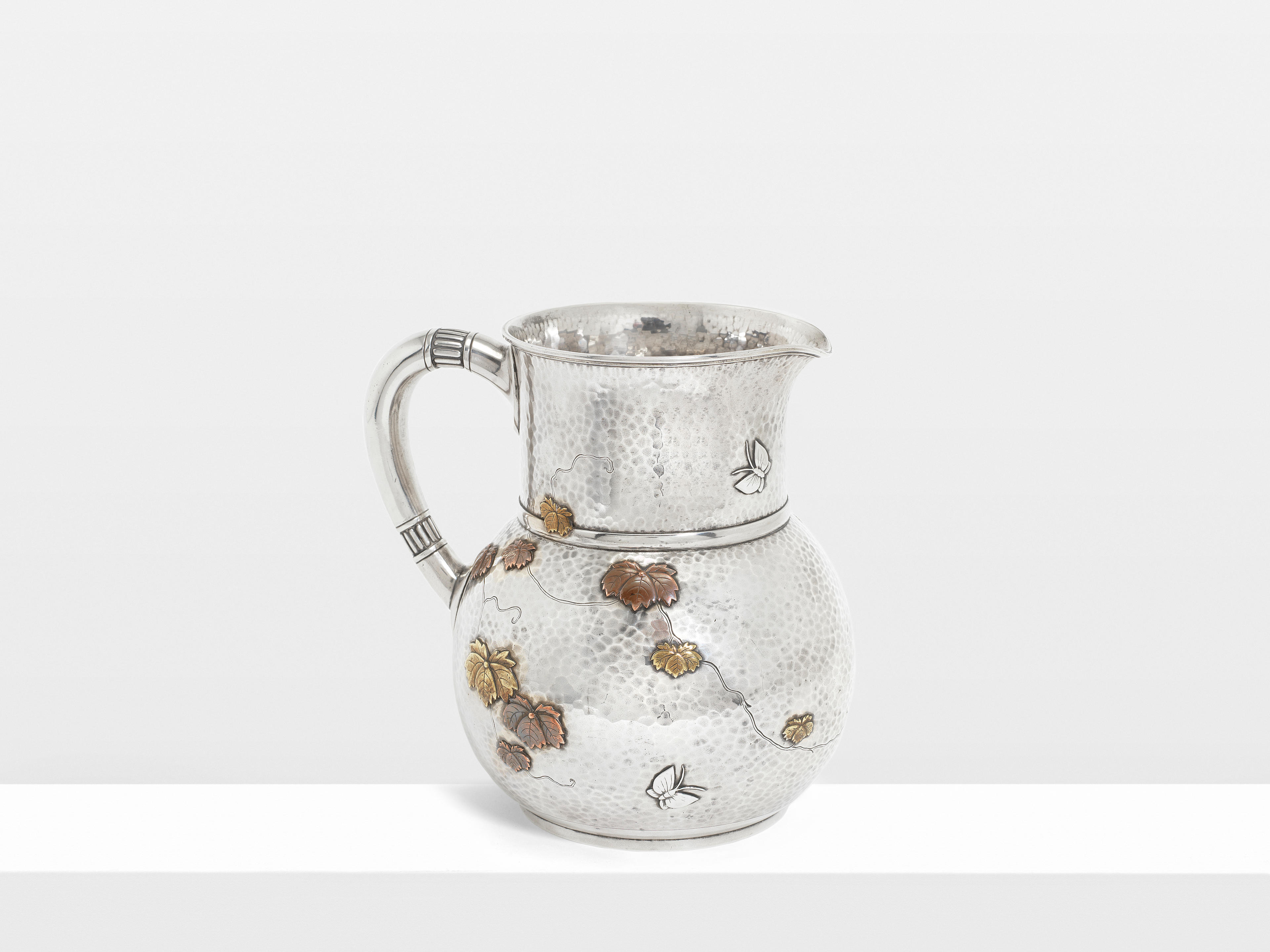 An American silver and mixed metals pitcher