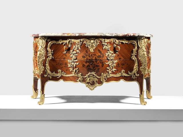 A large French late 19th century gilt bronze mounted tulipwood and amaranth marquetry serpentine commode in the Louis XV style