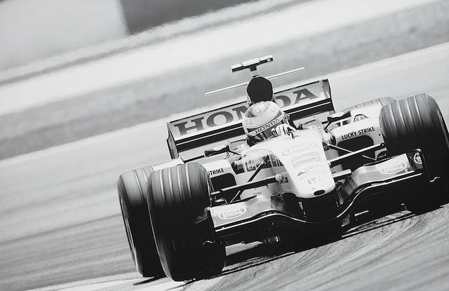 A VERY LARGE PHOTOPRINT DEPICTING JENSON BUTTON AT THE WHEEL OF HIS BAR LUCKY STRIKE HONDA,