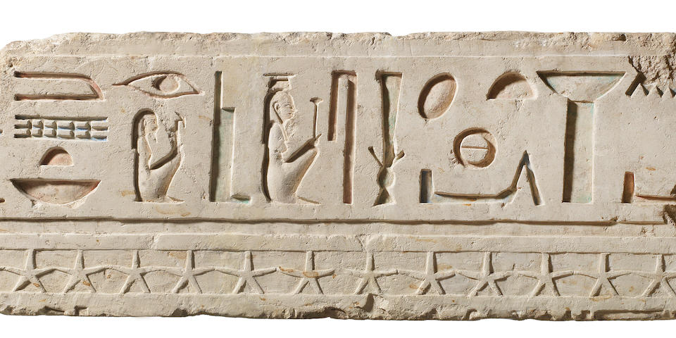 An Egyptian limestone relief with hieroglyphs